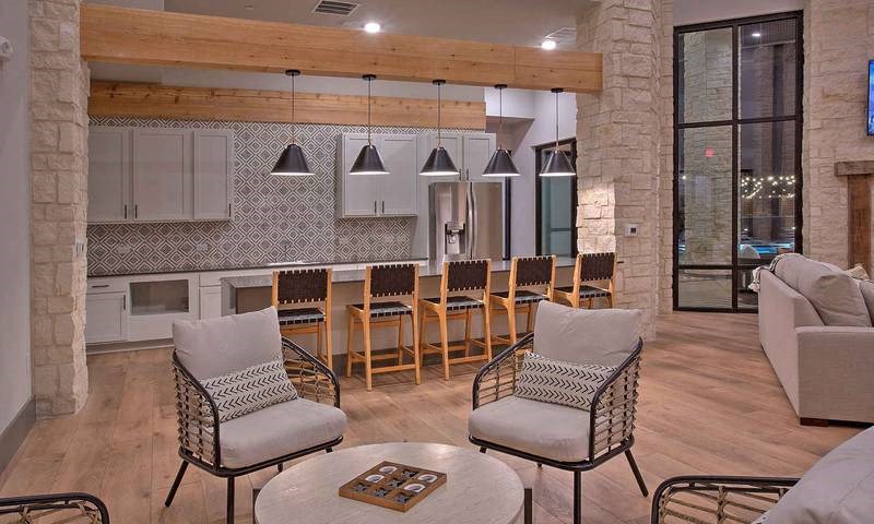 a store window with a display of wine bottles at Hunters Creek Apartments, Denton