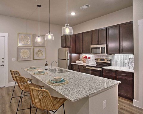 a kitchen with a marble counter top