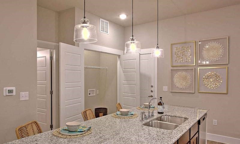 a kitchen with a sink and a counter top at Hunters Creek Apartments, Denton Texas