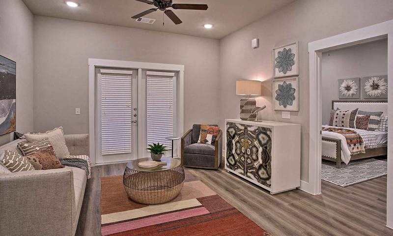a living room with furniture and a ceiling fan at Hunters Creek Apartments, Denton