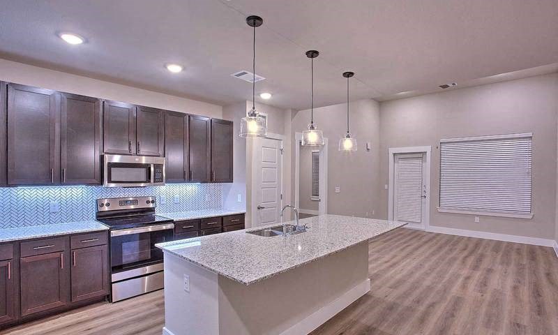 a kitchen with a sink and a counter top at Hunters Creek Apartments, Denton, TX