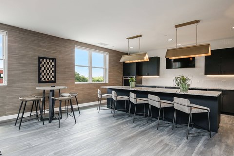 A modern kitchen with a bar area and a dining table set up.