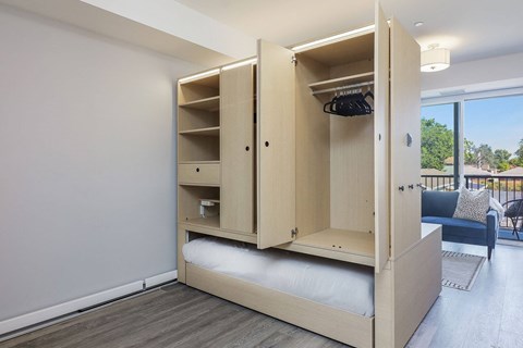 A bedroom with a large bed and a wardrobe.