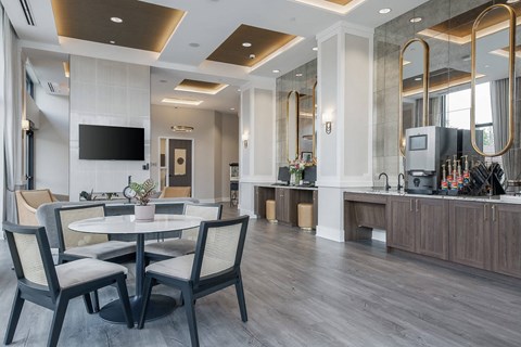 A modern dining room with a round table and chairs.