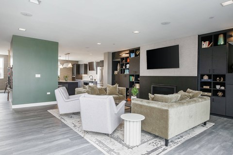 A modern living room with a grey sofa and a white armchair.