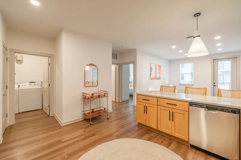 A kitchen with wooden floors and white walls.