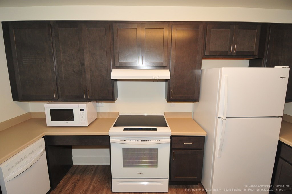 A kitchen with a white refrigerator and white oven.