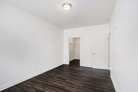 A room with a white door and a light on the ceiling.