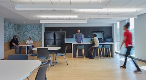 A group of people are gathered in a modern office space.