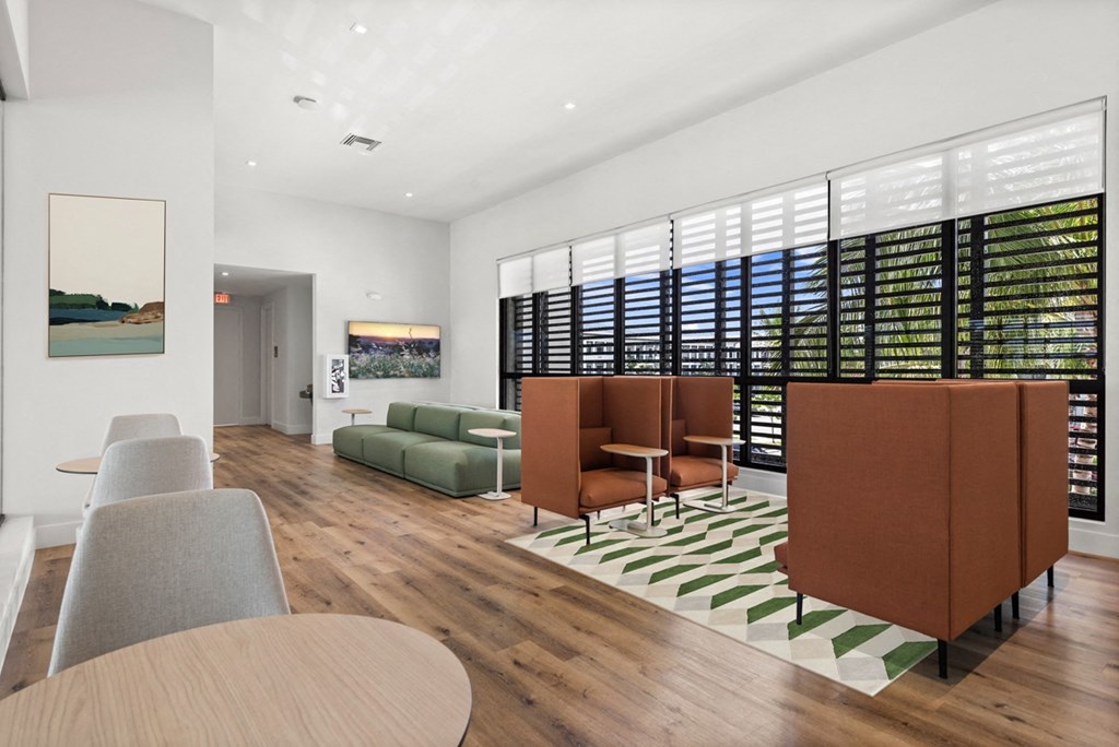 a living room with white walls and hardwood floors
