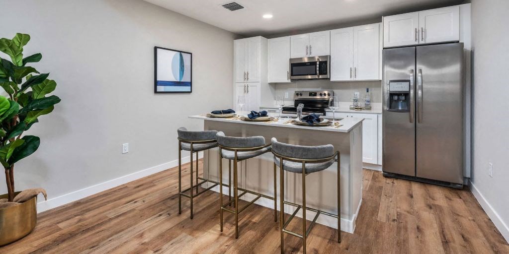 a kitchen with a center island with three stools