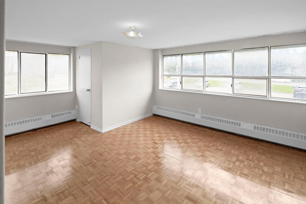 the living room of an empty house with wood floors
