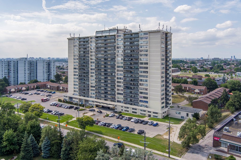 an aerial view of a tall building in a parking lot