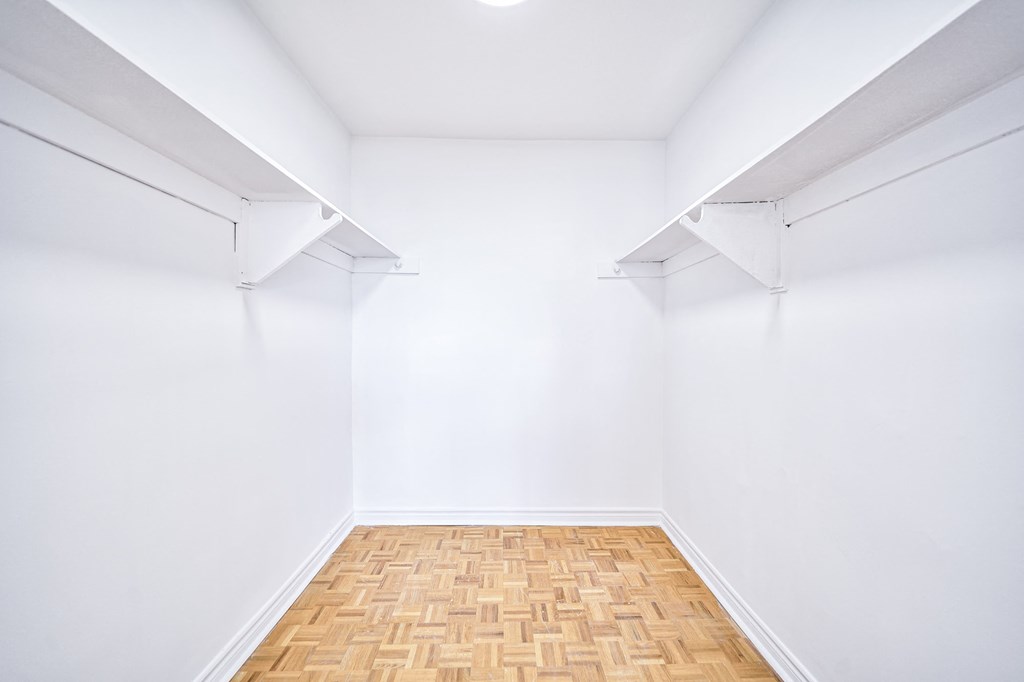 an empty room with white walls and a wooden floor