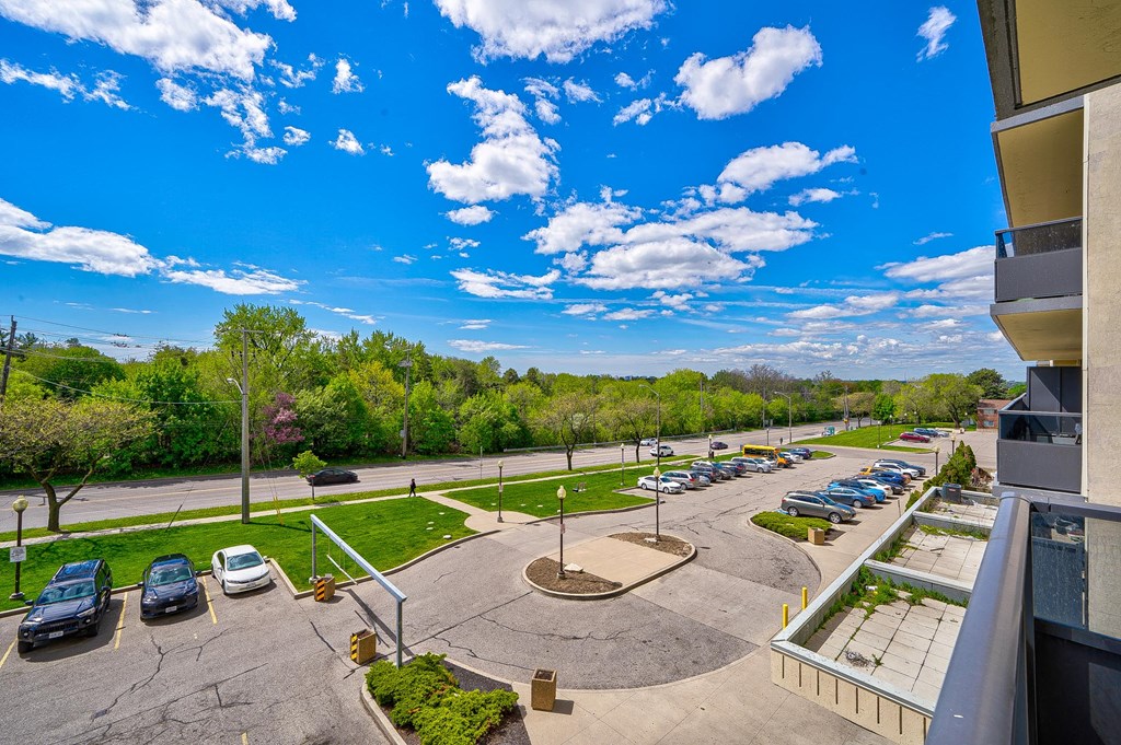 a view of a parking lot from a balcony with cars parked