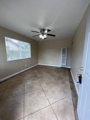 a room with a ceiling fan and a window