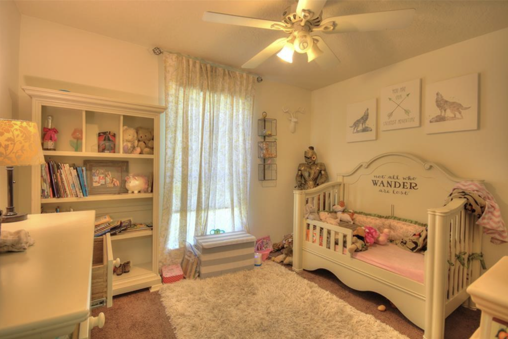 a nursery with a crib and a dresser