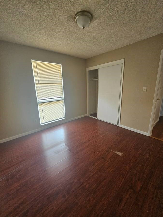 an empty room with a window and a door