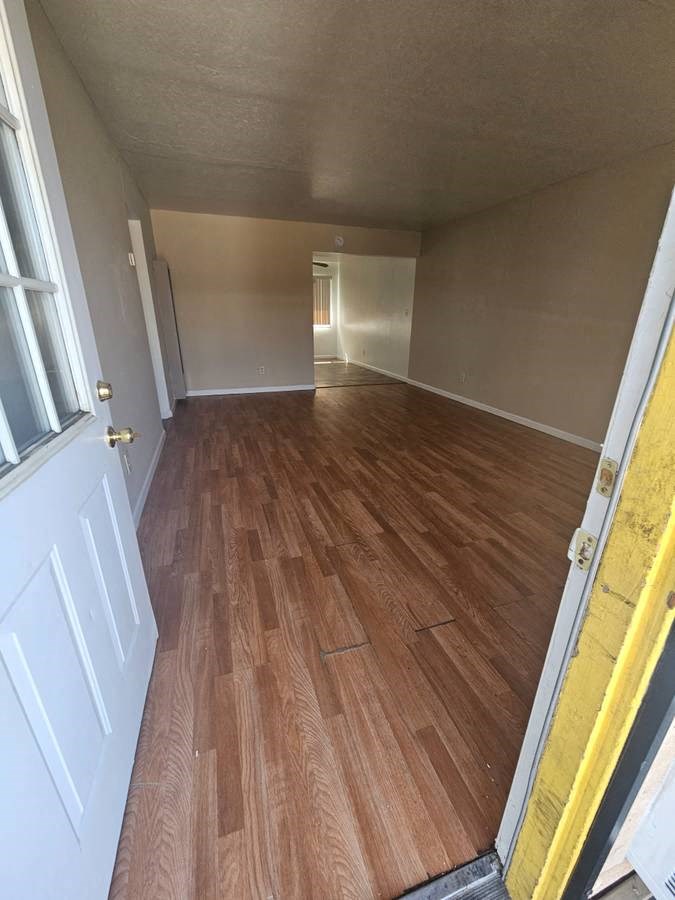 a room with a wooden floor and a white door