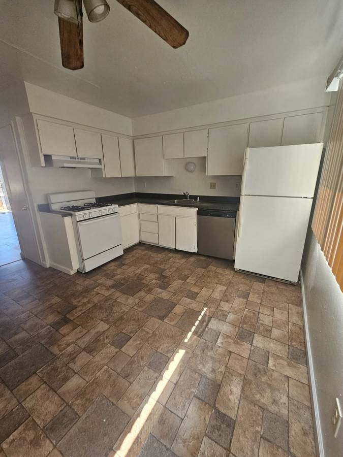 a kitchen with a stove a sink and a refrigerator