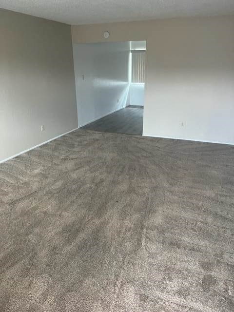 an empty room with a carpeted floor