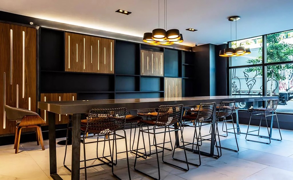 A modern dining room with a long table and chairs.