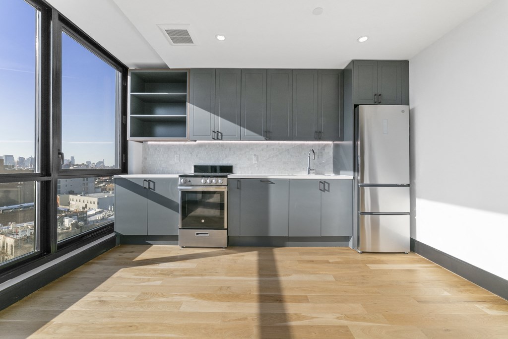 A modern kitchen with a view of the city.