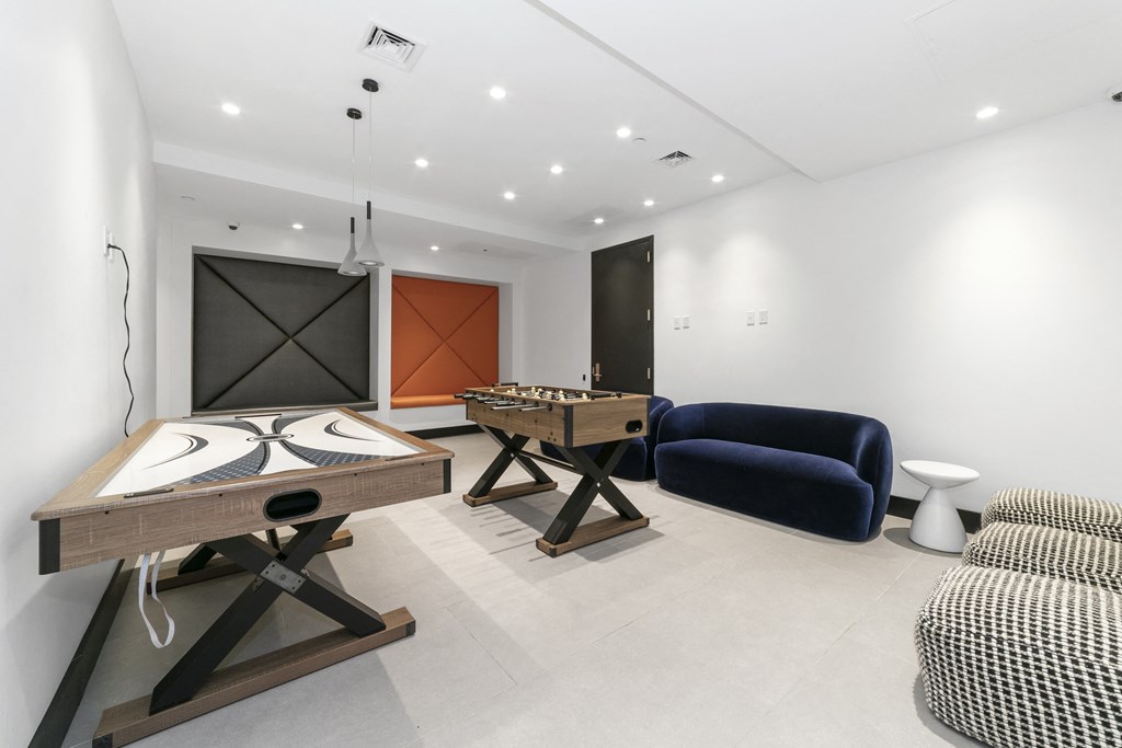 A room with a table, chairs, and a couch.