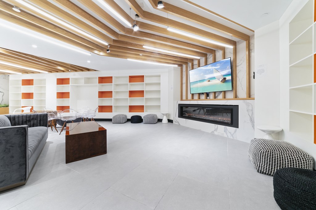 A modern living room with a fireplace and a television.