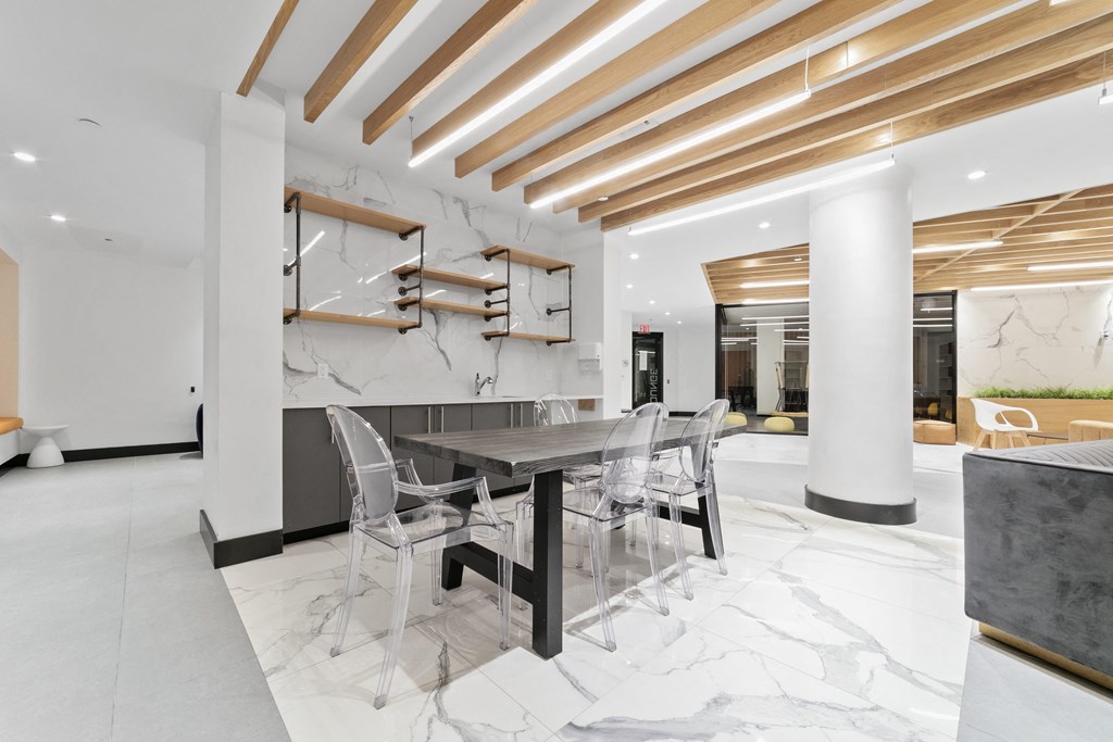 A modern dining area with a table and chairs.
