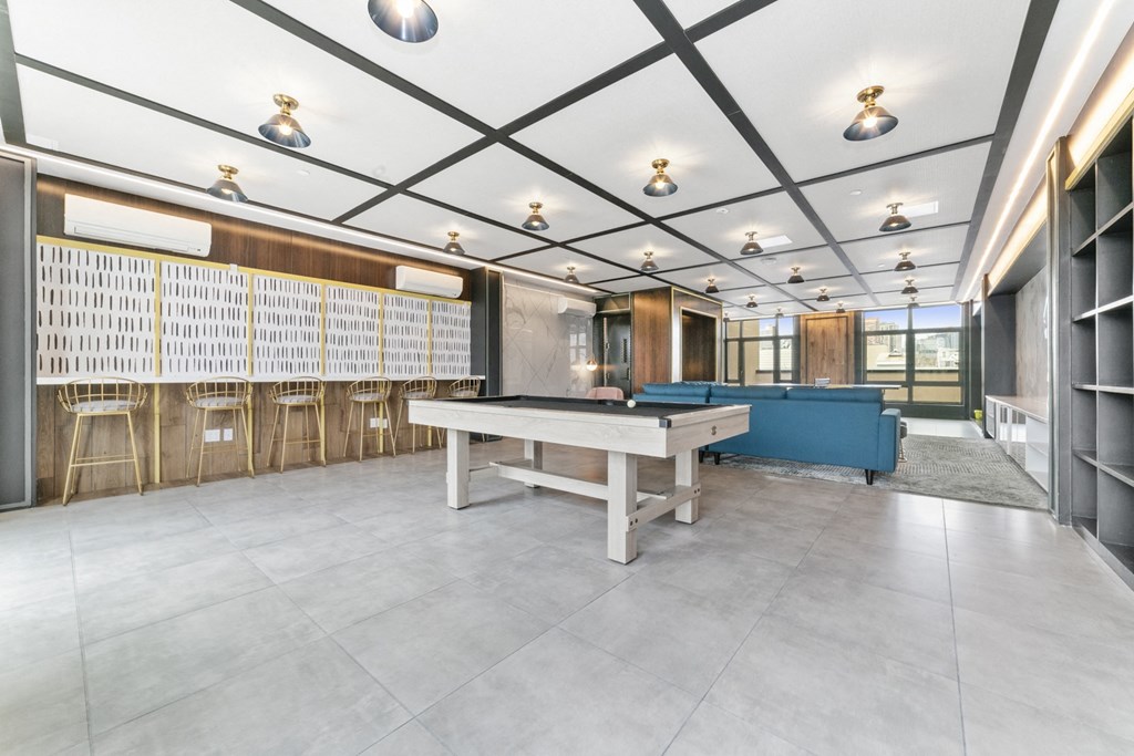a game room with a pool table and a blue couch