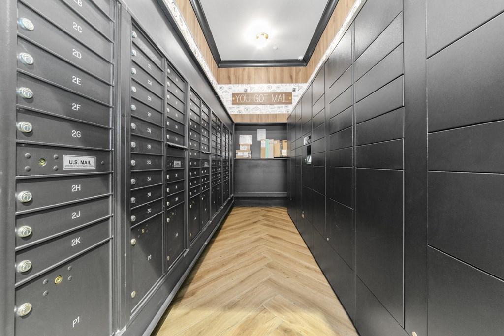 a lockers room with wooden floors and black cabinets