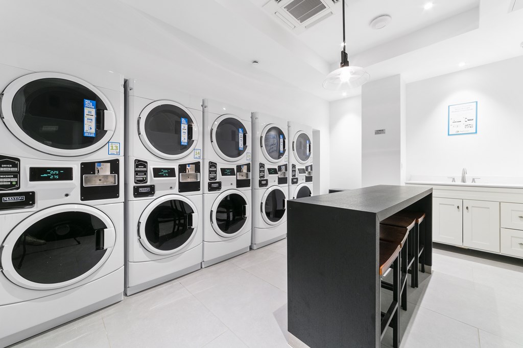 A row of washing machines in a laundromat.