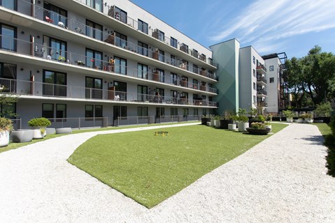 Apartment complex with a green lawn in front.