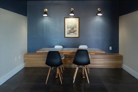 A dining room with a wooden table and chairs.