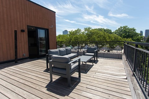 A wooden deck with two chairs and a table.