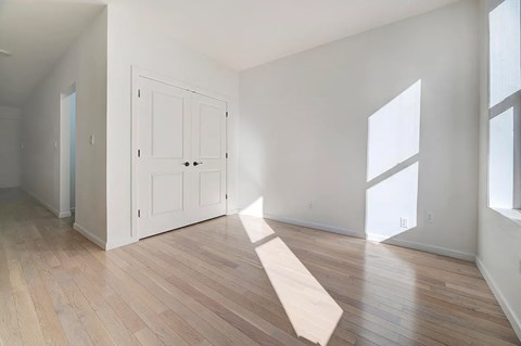 A room with a white door and a white mat on the floor.