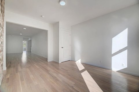 A room with wooden floors and white walls.