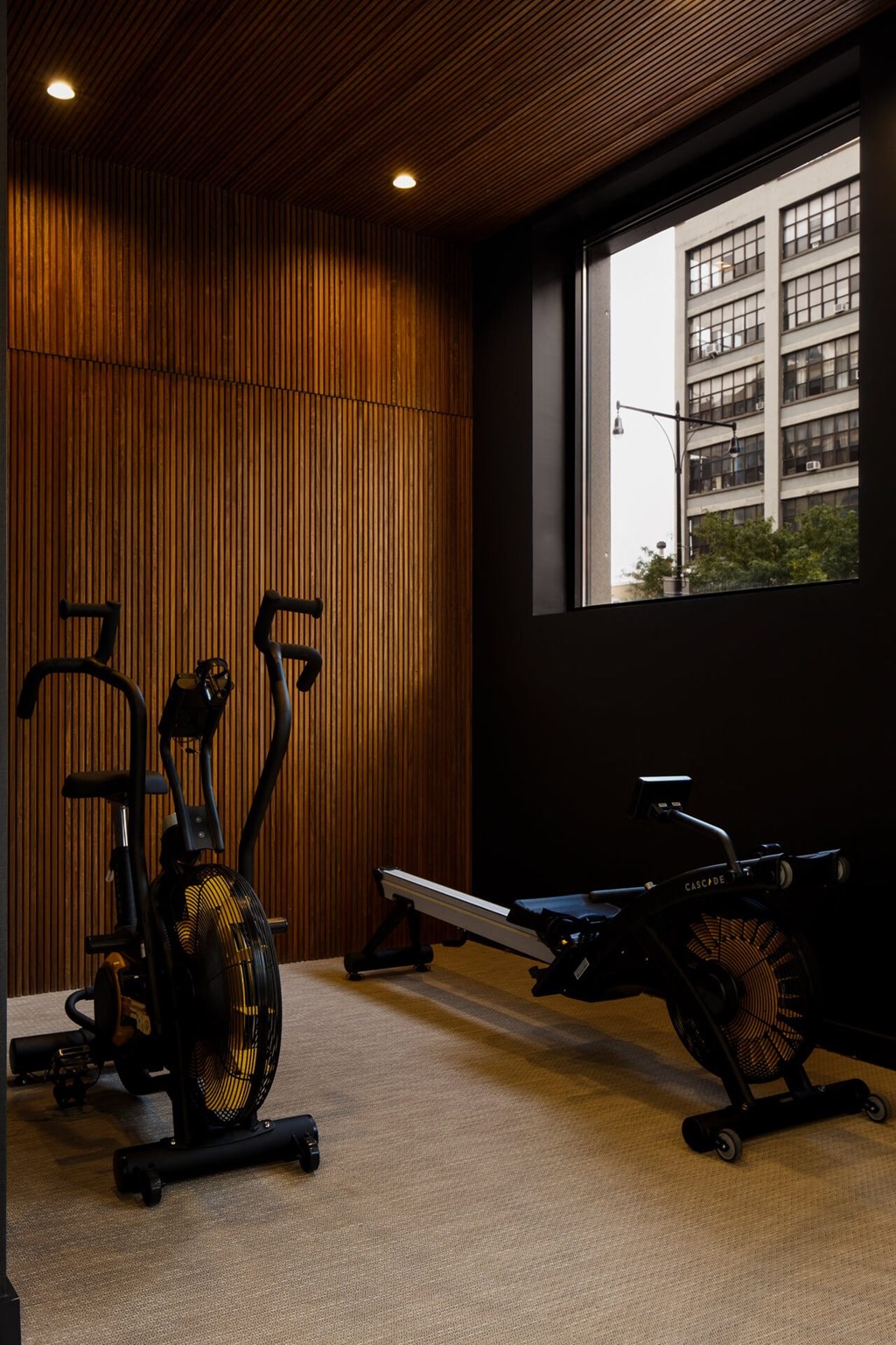 a gym with exercise equipment and a large window