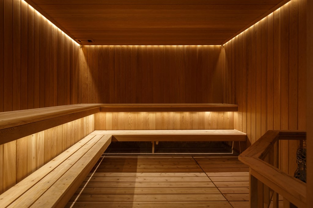 a wooden sauna with wooden walls and a bench