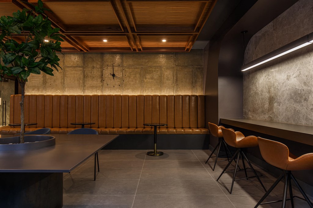 a dining room with tables and chairs and a plant