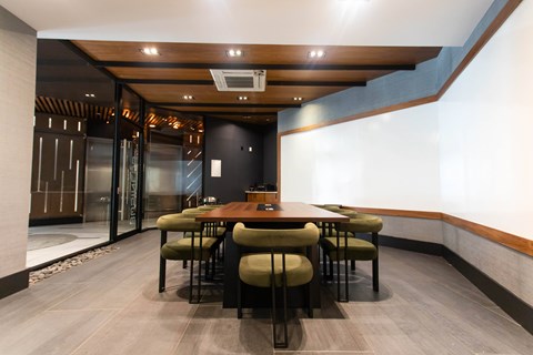Private dining room with wood table and upholstered chairs at 1134 Fulton Street Apartments, Brooklyn, NY