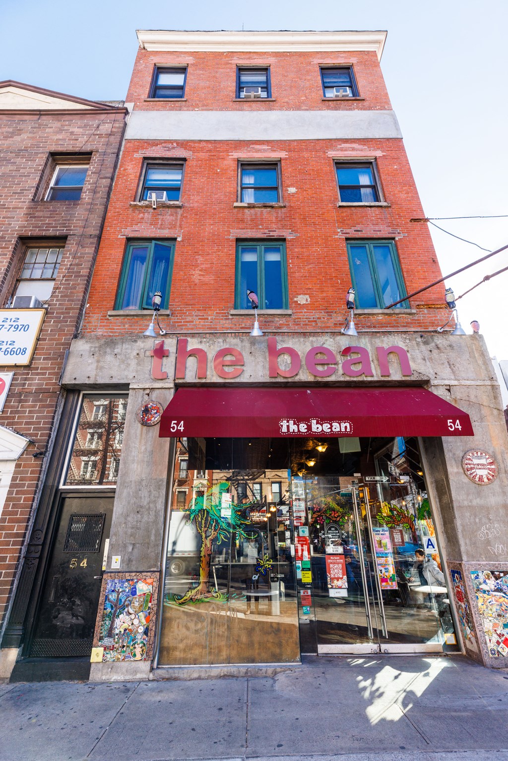 a brick building with a sign that reads the bean on the front of it