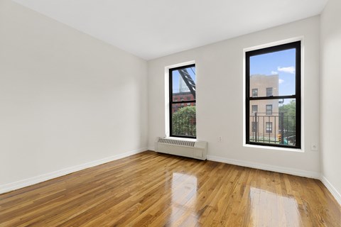 A room with a window and a radiator on the wall.
