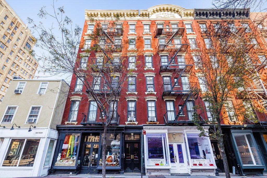 a building on a city street with a fire escape