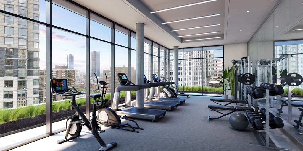 a gym with a view of the city at The Lively, Jersey City New Jersey