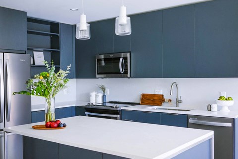 a kitchen with blue cabinets and a white counter top