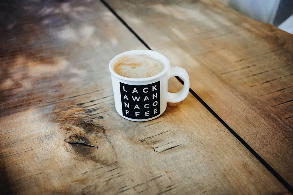 a cup of coffee on a wooden table at The Lively, New Jersey, 07302