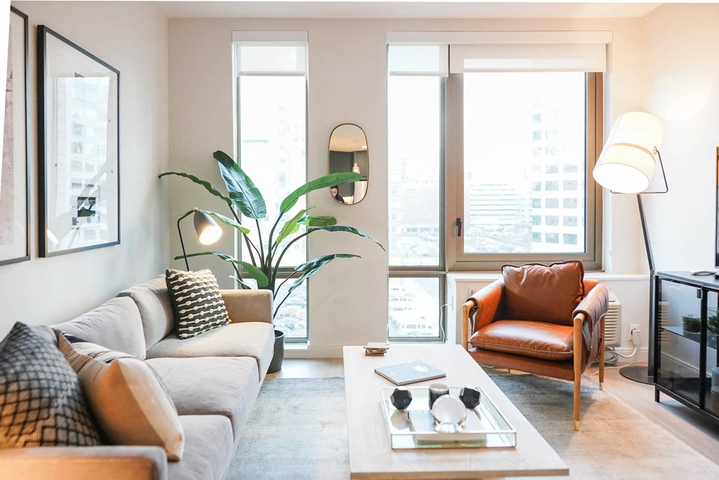 a living room with a couch and a chair and a table at The Lively, Jersey City New Jersey