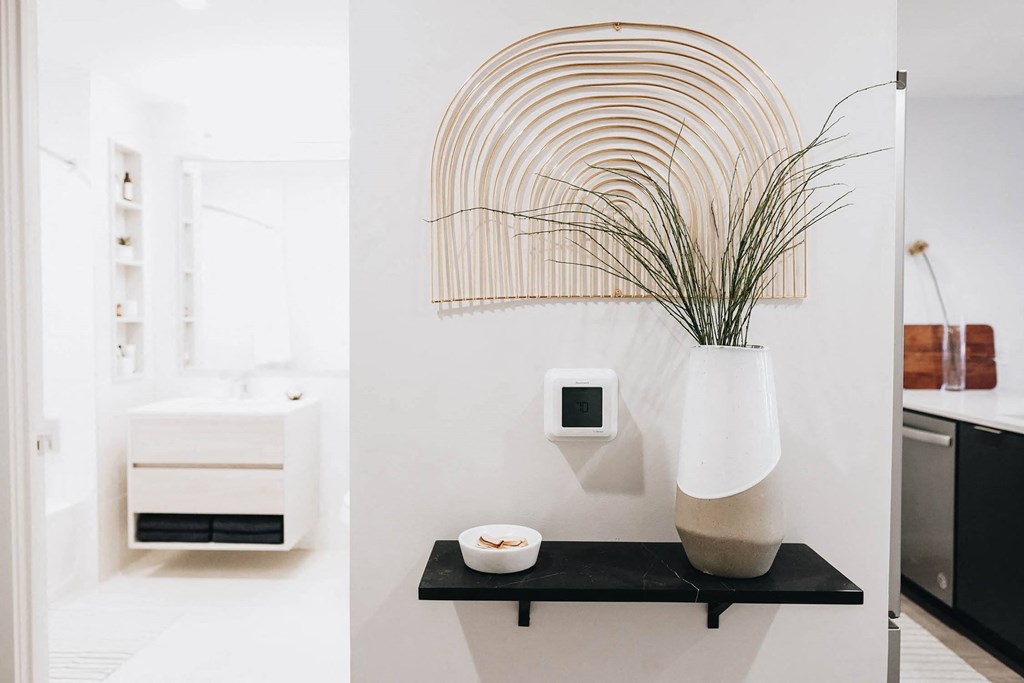 a black shelf with a vase and a plant in a bathroom at The Lively, New Jersey
